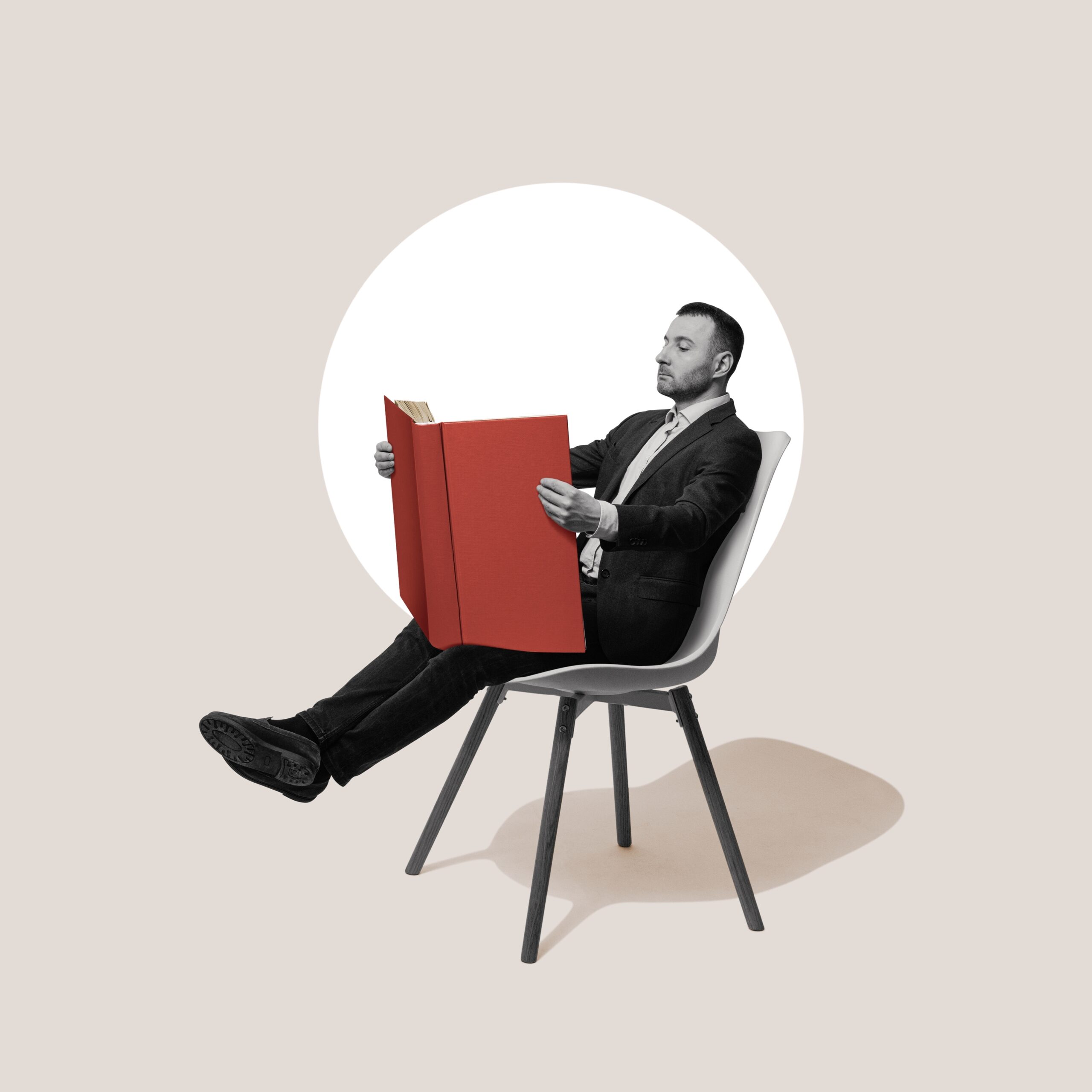 A man reading a large book, symbolizing product knowledge.