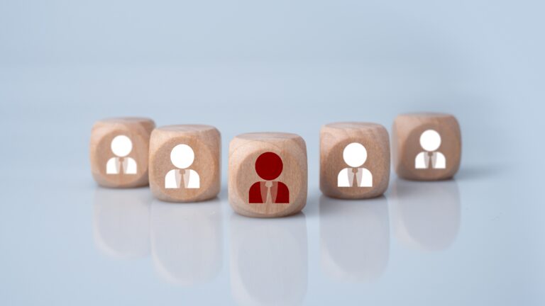 Wooden blocks representing individuals with each marketing role.