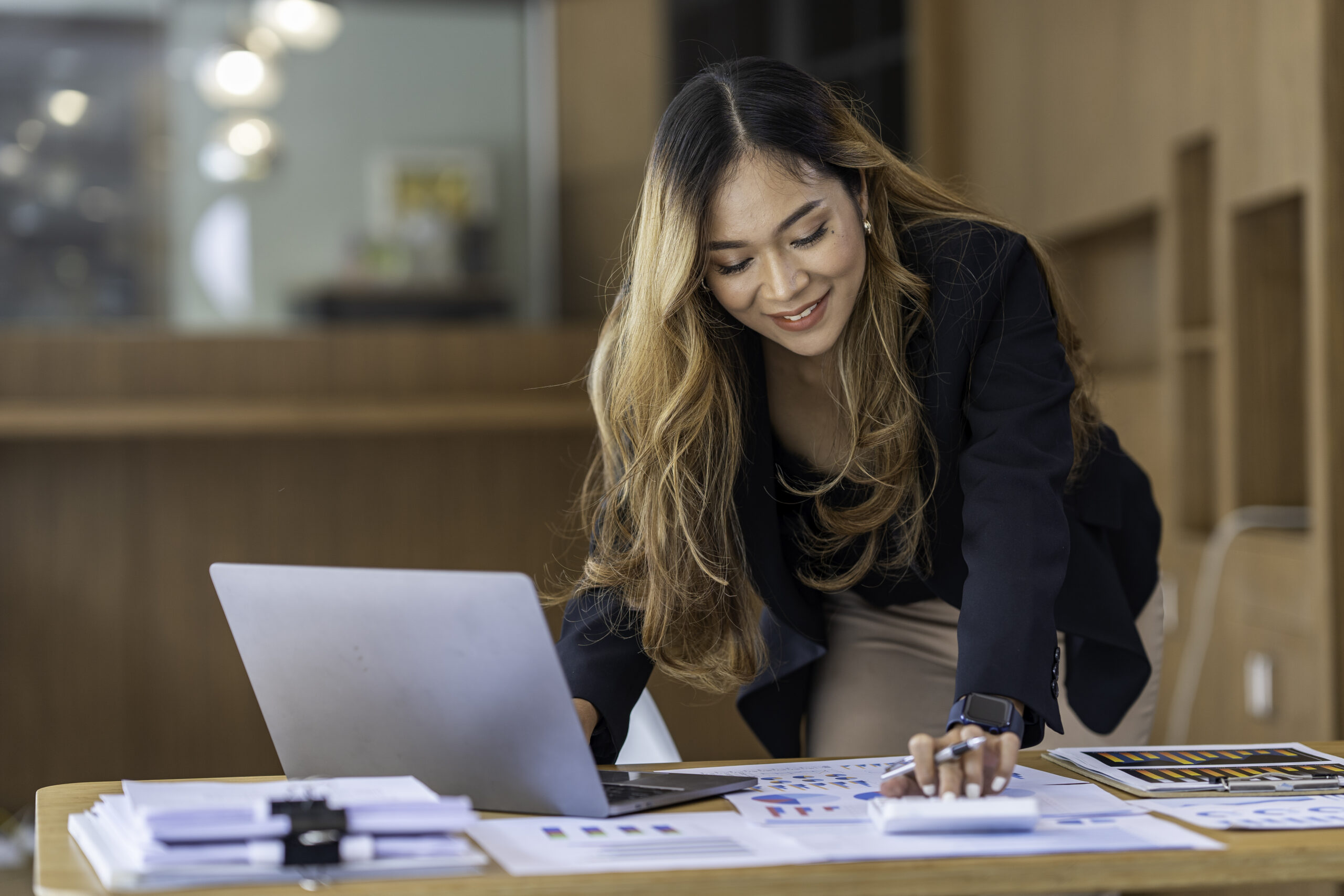 A female ambassador working with a laptop.